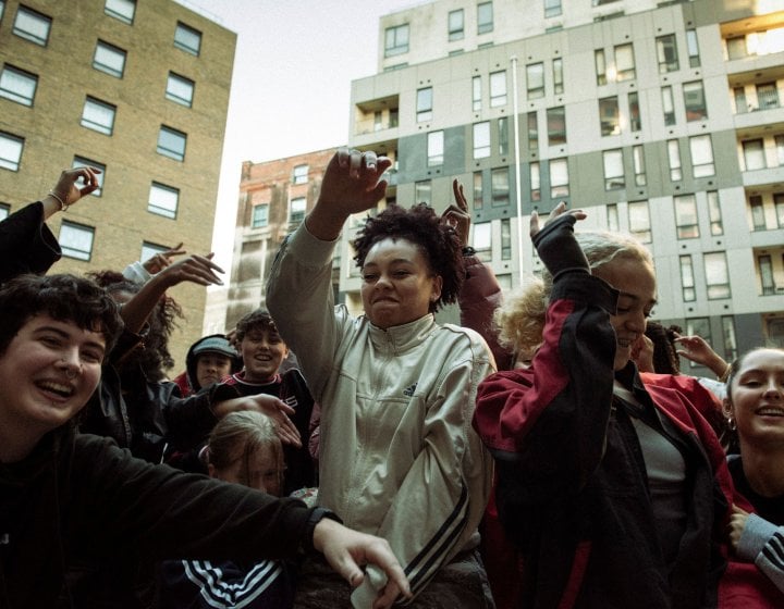 Young people dancing outside in an urban city setting