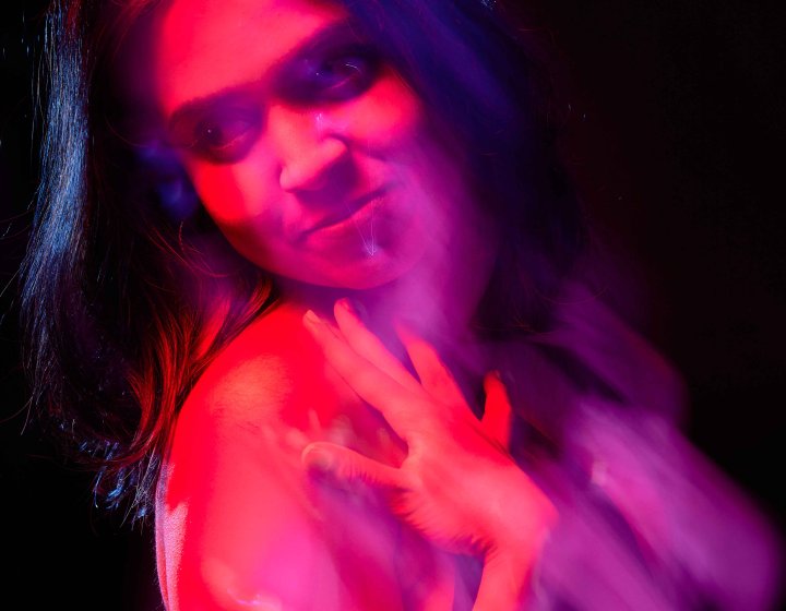 Pink tinted headshot of Ranya Iyer