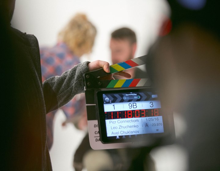 A filmmaker holding a clapper board 