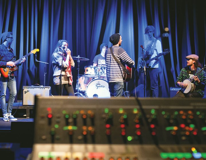 Band on a stage warming up with blue lighting