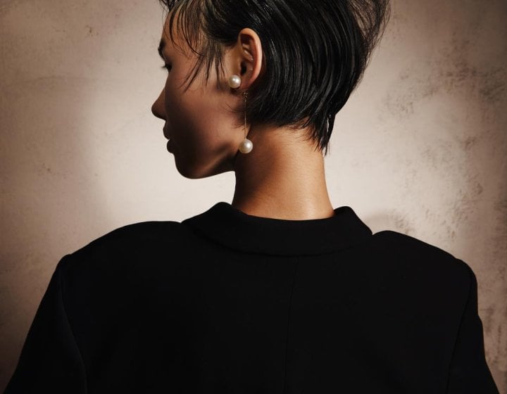 Photograph of the back of the head of a woman with cropped black hair