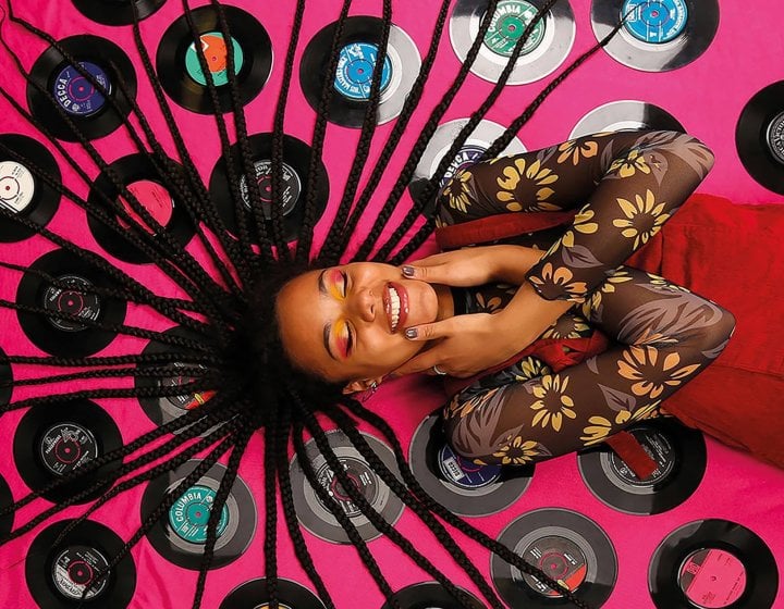 Model lying on records with hair spread out over them