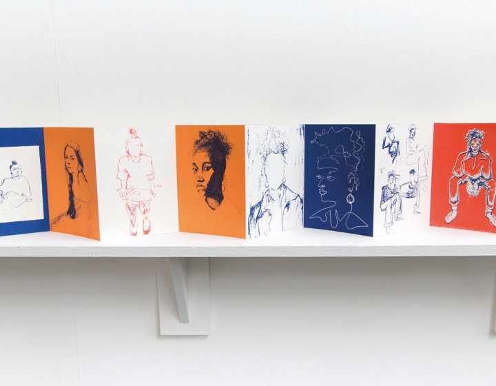 A fold out book of drawings on a shelf