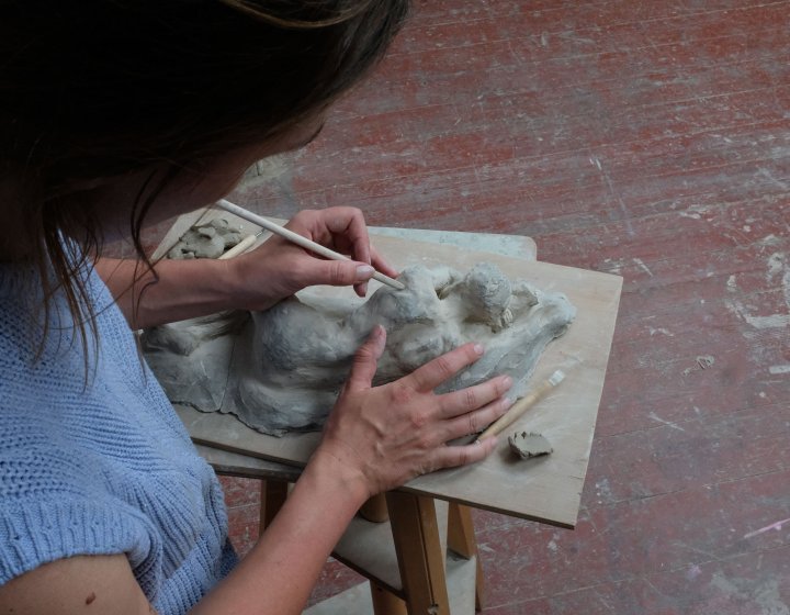 Emily Roberts making a reclining figure sculpture