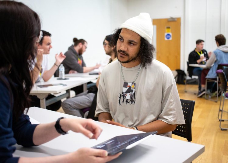 A student taking part in a portfolio review at the Falmouth University Games Expo