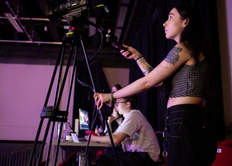 A Falmouth University student operating a camera at the 2025 Games Expo
