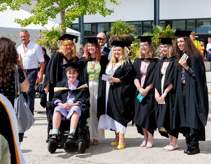 A group of students in gowns at Falmouth University's 2023 graduation
