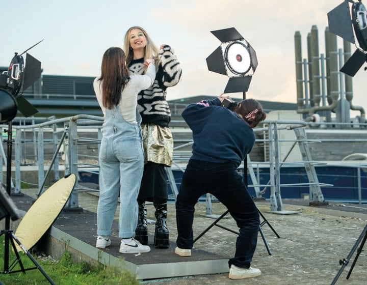 Students styling fashion shoot on rooftop