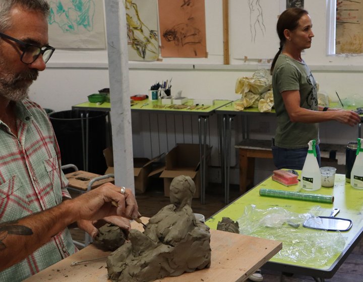 Two students creating sculptures