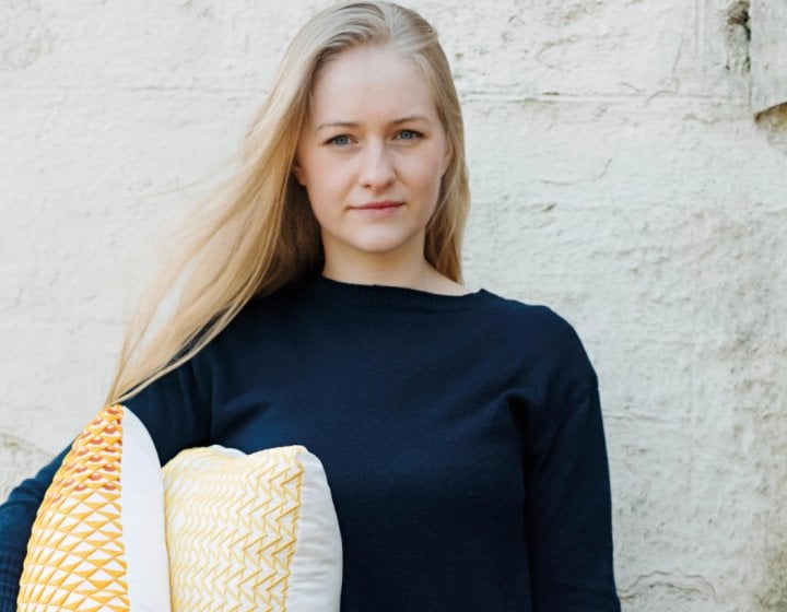 A woman holding some cushions