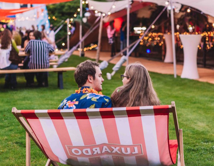 Two students sat on an oversized deckchair