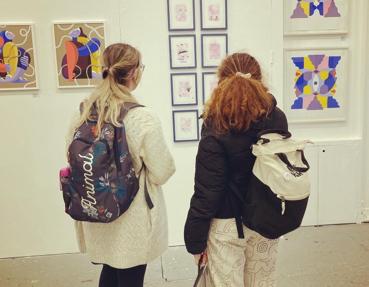 Students admire work at an illustration exhibition in Bristol