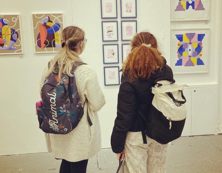 Students admire work at an illustration exhibition in Bristol 