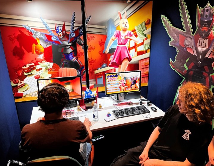 Two male students playing a game at Falmouth University's Games Expo