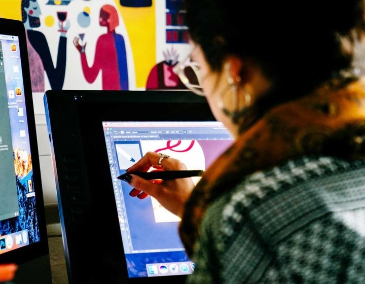Visual Communication student drawing on a tablet