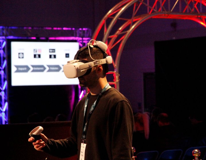 A man wearing a VR headset and holding a control