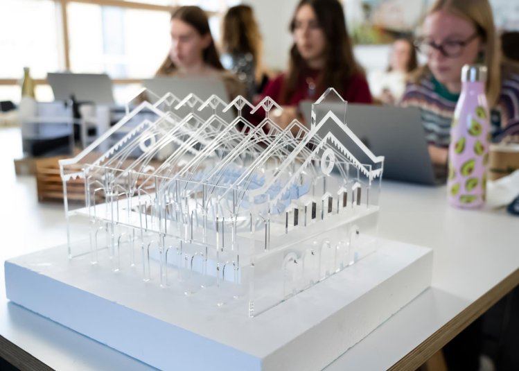 Clear plastic model of a building with a pitched roof