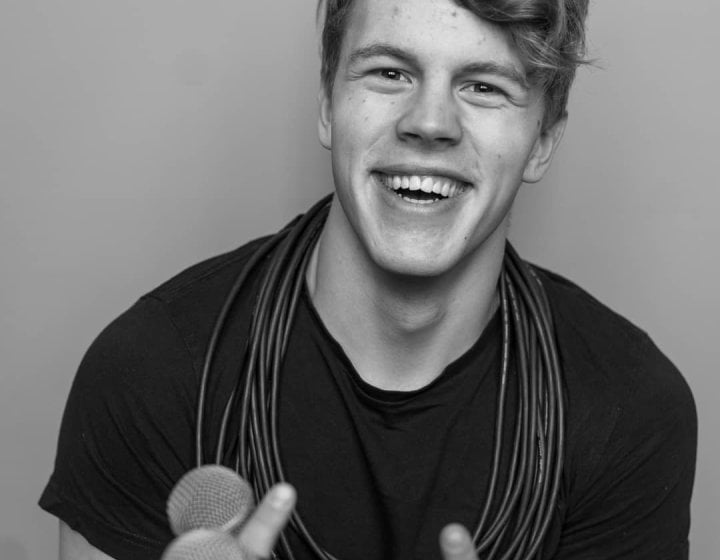 A man holding microphones in black and white