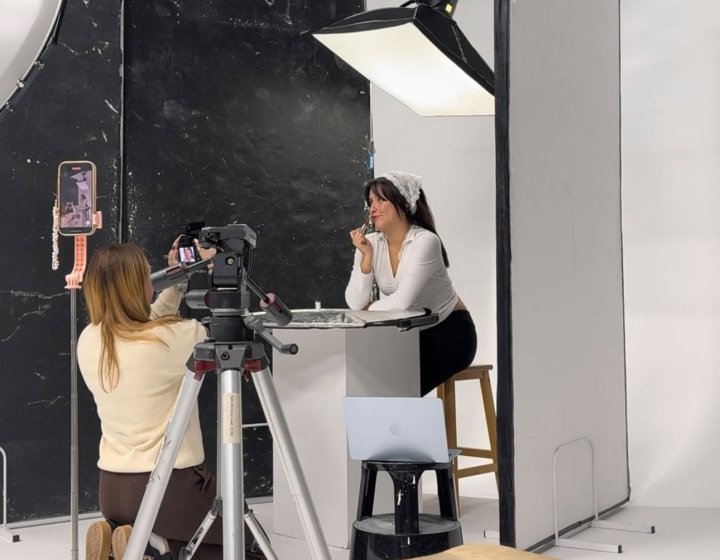 A Falmouth University student photographing another student in the studio
