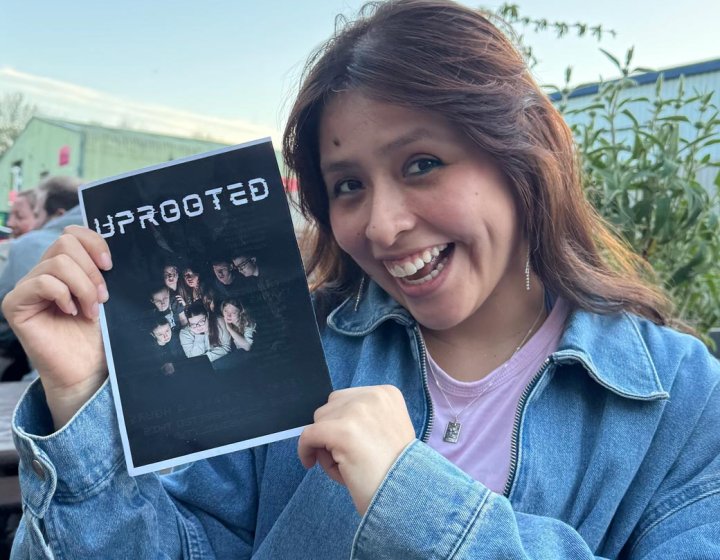 A Theatre & Performance student holding up a poster