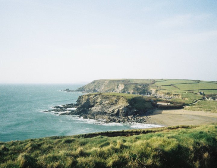 Landscape shot of the Cornish coast - the ocean and cliffs are visible