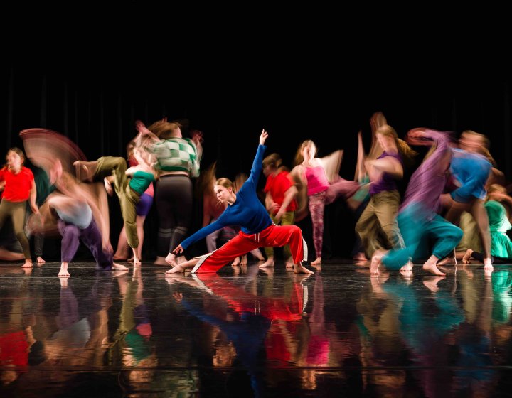 Group of dancers in brightly coloured clothes