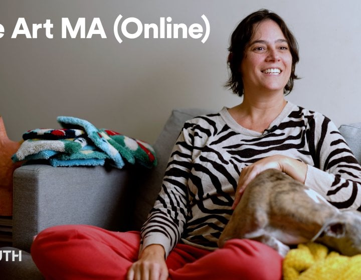 Fine Art online student Karina sat on a sofa with a dog in her lap