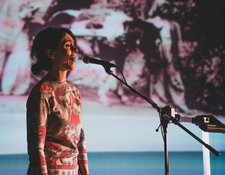 A woman singing into a microphone