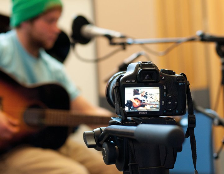 Camera shooting student playing guitar