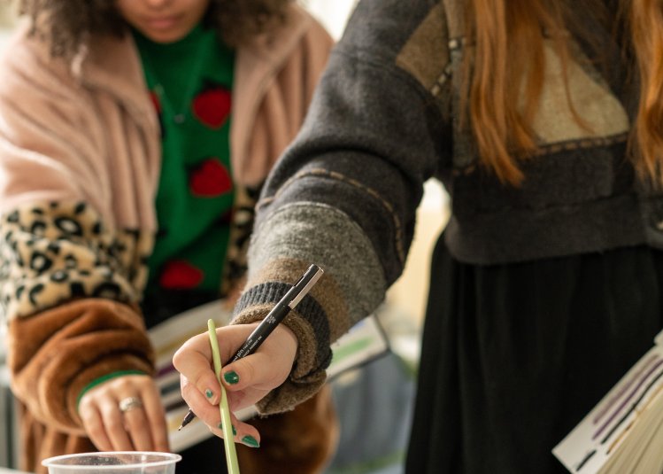 A photograph of two students with paintbrushes