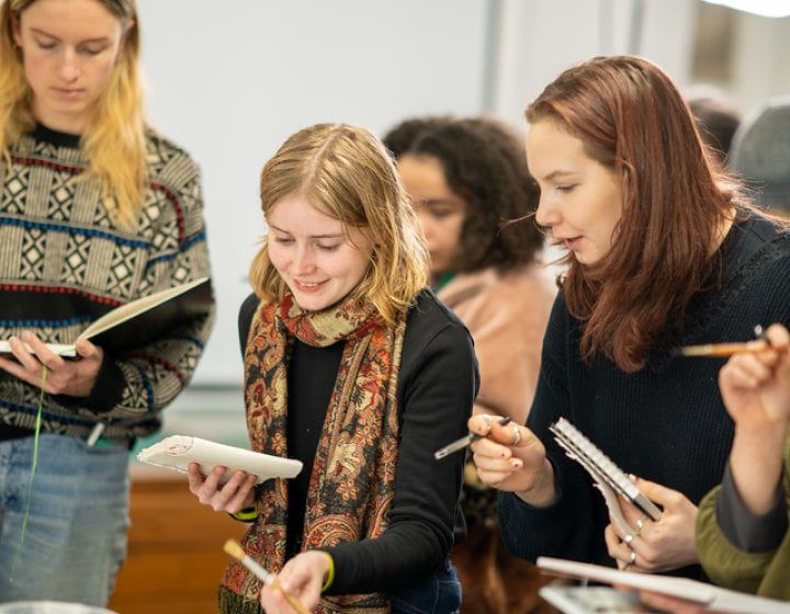 Students painting in a workshop at Falmouth Illustration Festival 