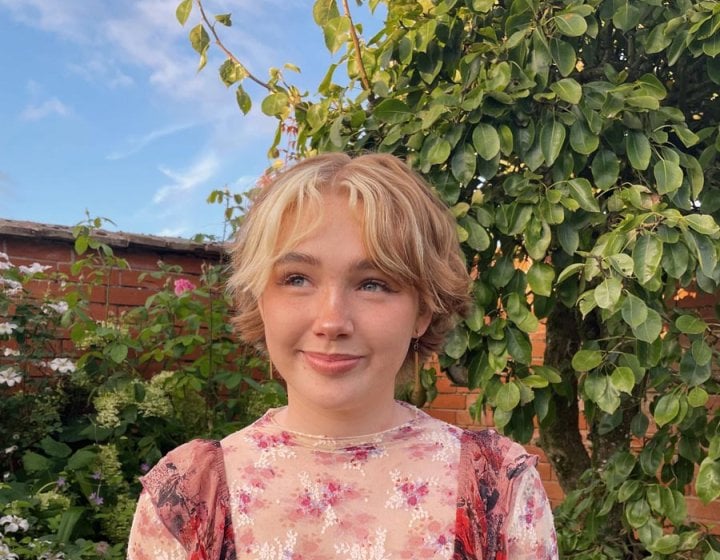 Photograph of Falmouth graduate Niamh Shergold outside with blue sky