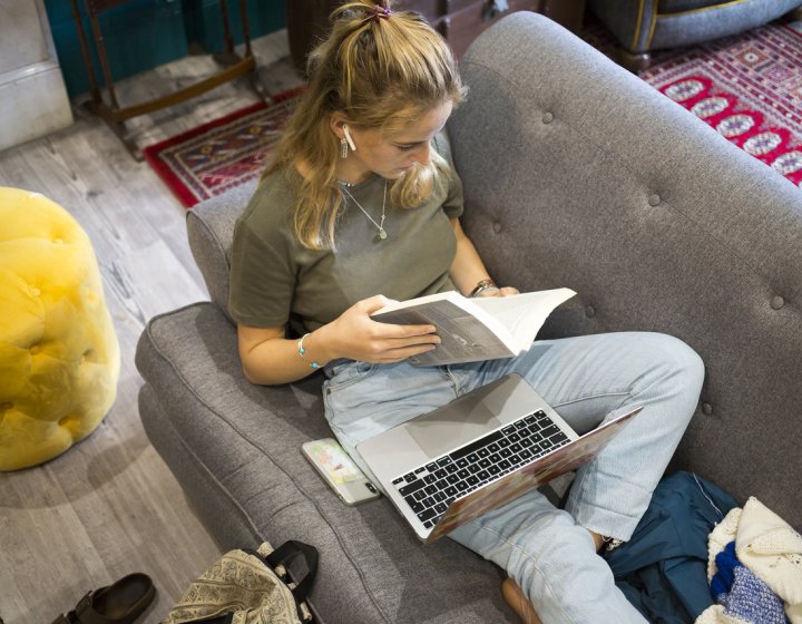 A student sat on a sofa