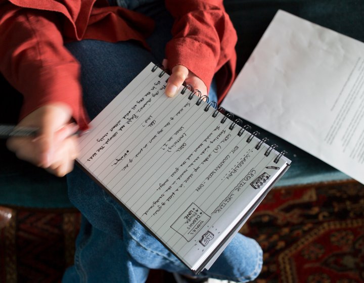 A woman writing in a notebook
