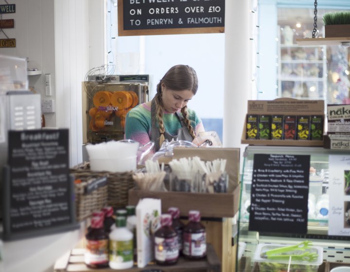 Girl with long hair working behind a counter in a shop