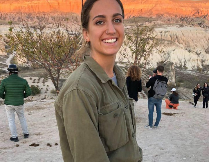 A woman smiling, wearing a green shirt