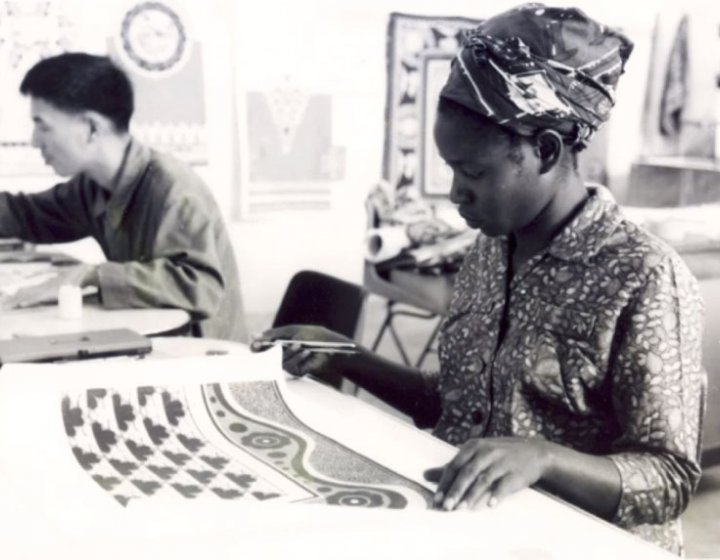 A woman examines textiles 