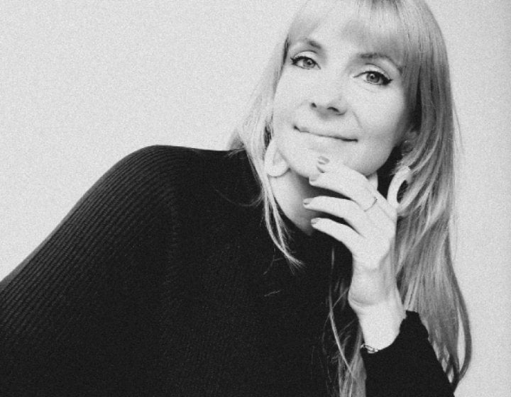 A woman looking into the camera smiling