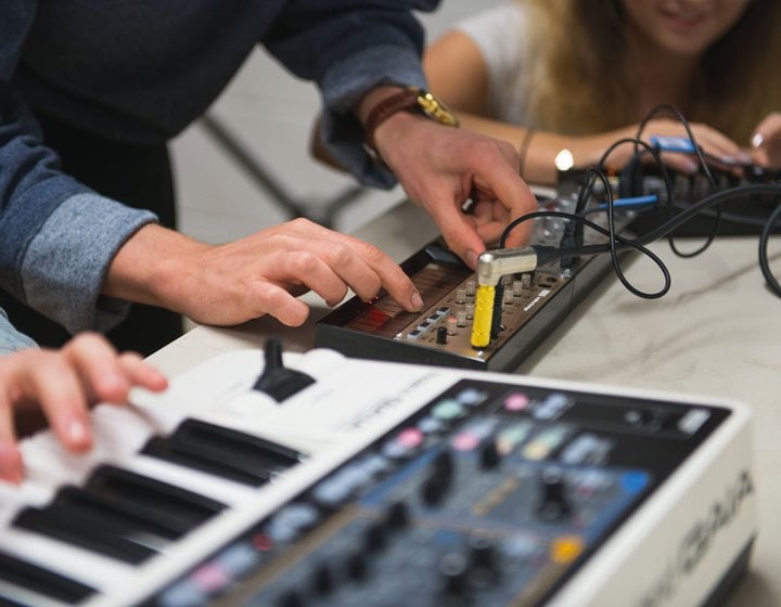 Close up of hands on keyboard and mixer