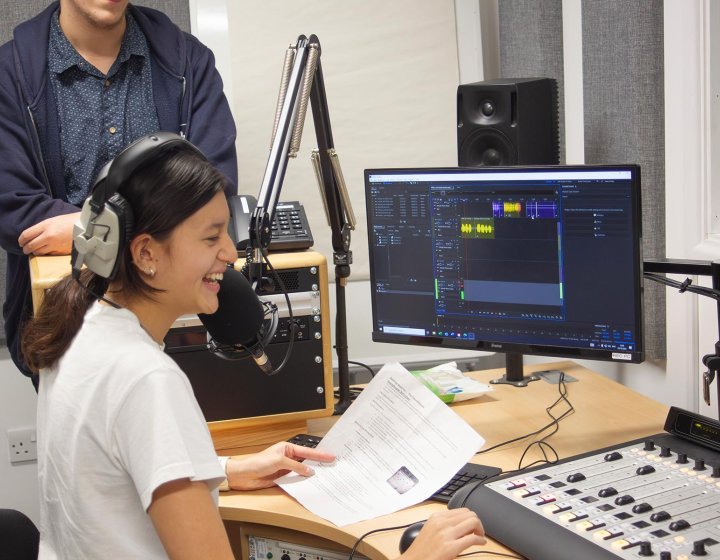 A female student working in an radio studio at Falmouth University