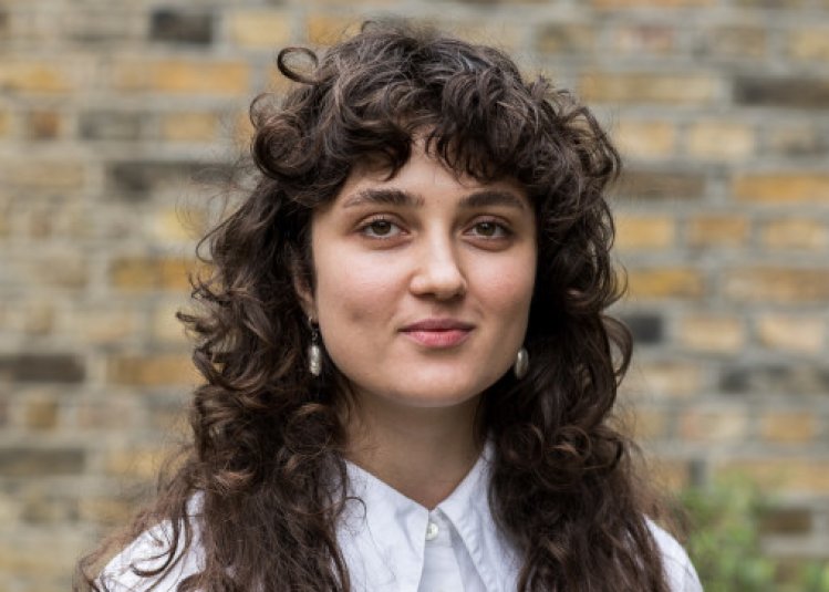 A woman smiling into the camera