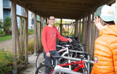 Students chatting in bike store on Penryn Campus