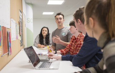 Falmouth University Entrepreneurship students in the studio with a laptop