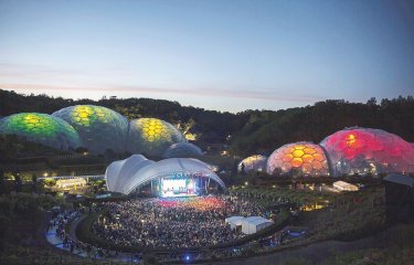 Aerial view of the Eden Project's domes lit up during an Eden Session's event.