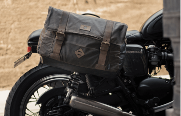 a leather bag strapped to the side of a motorbike