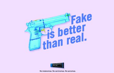 Blue toy gun with the text 'Fake is better than real'