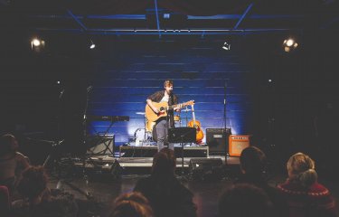 A guitarist performs on stage 