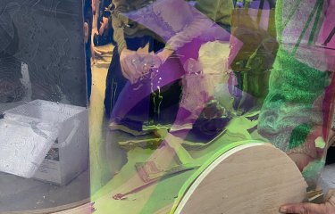 Students working with materials to create a sculpture