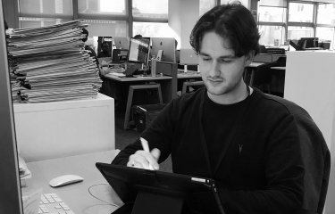 Illustration graduate Jake Hawkins at his desk