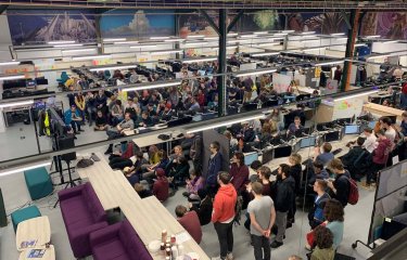 A crowd of students in the Games Academy with computers